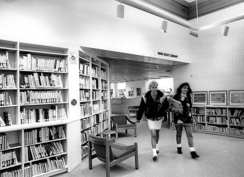 Two people walk through lobby