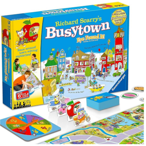 City scene on a blue background on box cover with cards, spinner, tokens, and game board in front.