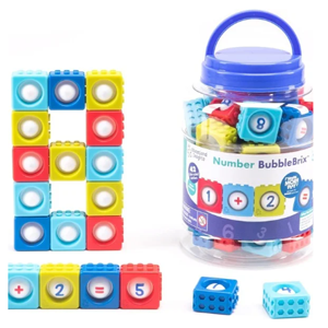 Colorful building blocks with numbers on them contained in a clear bucket.