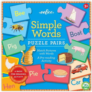 Blue box cover with multicolored puzzle pieces with words on them.