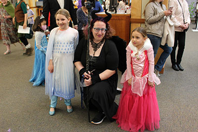 Alissa (as Maleficent) is in between two children in fairy tale costumes.