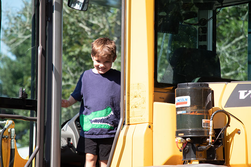 Child on yellow construction truck