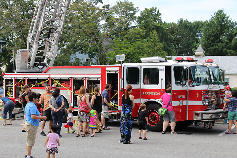Line of parents and children awaiting to go inside the ladder fire truck.