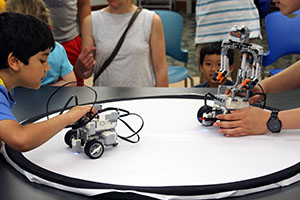 Children battling their custom built LEGO® MINDSTORM® Sumo Bot with the Parity Bits