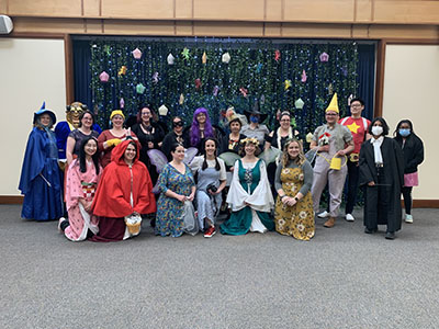 Cary Library staff all dressed in costumes gather for the Fairy Tale Ball 2022.