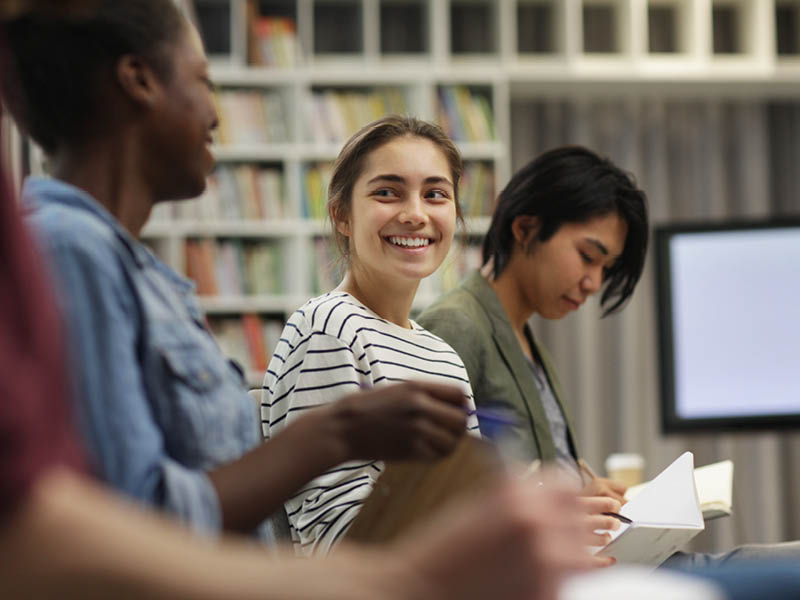 Person smiling in a book group